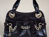 an image of a black purse with silver hardware on the handles