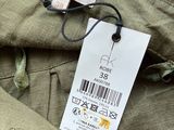 the label on the back of a khaki jacket is attached to the back of a khaki jacket