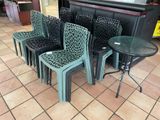 four chairs and a table on the floor in a store