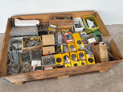 a wooden box filled with assorted tools on the floor
