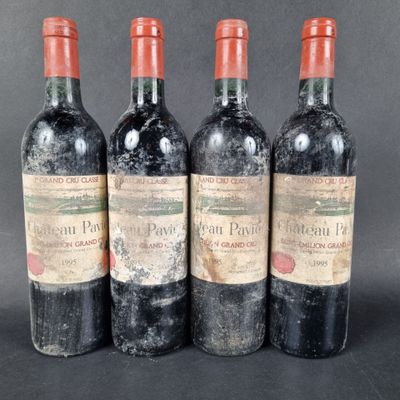 three bottles of red wine sitting next to each other on a table
