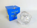 a crystal ball sitting next to a box of snowballs