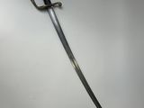 a close up of a sword on a white surface
