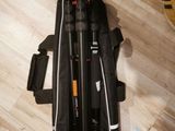 a person standing on a wooden floor with a camera and a tripod