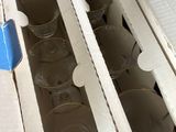 many empty glasses in a box on the floor