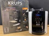 a close up of a coffee machine on a table with a box