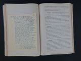 an open book on a table with a black background
