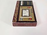 a box with a clock inside of it on a white surface