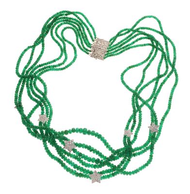 a close up of a green beaded necklace on a white background