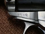 a close up of a gun on a brown surface