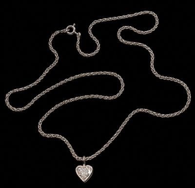 a close up of a heart shaped pendant on a chain