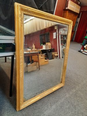 a large mirror sitting on the floor in a room