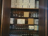 a large wooden cabinet with many glasses on it