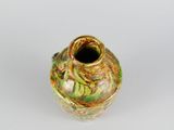 a small vase with a green and yellow design on it