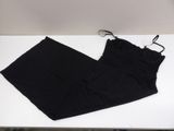 black pants on a white table with a pair of scissors