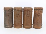 three old fashioned wooden containers are lined up on a white surface