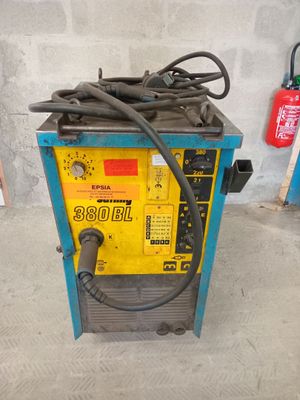 un gros plan d'une machine à souder à laquelle est raccordé un tuyau