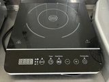 a black stove top with a black burner on it