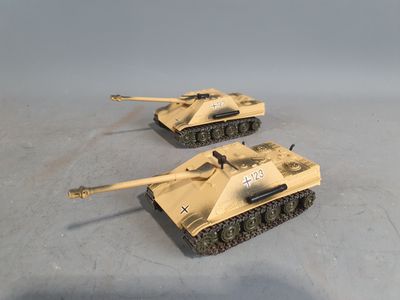two toy tanks sitting on top of a table next to each other