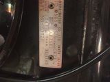 a close up view of a toaster with a thermometer on it