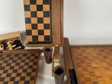 several pieces of wooden chess and checkers laid out on a white surface