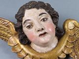 a statue of an angel with a surprised look on it ' s face
