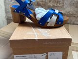 blue and white sandals on a cardboard box on a table