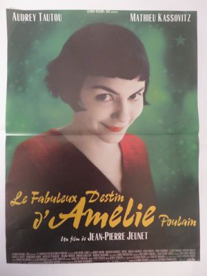 une vieille affiche de cinéma représentant une femme en robe rouge