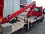 a red truck with a crane on the back of it