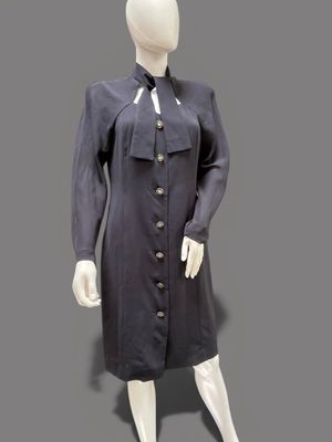 an image of a mannequin wearing a black dress and tie