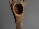 a close up of a wooden object on a gray surface