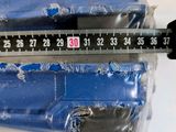 someone is measuring the height of a piece of plastic with a ruler