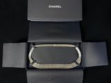 the box is open to show the contents of a chanel bracelet
