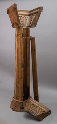 an image of a tall wooden object with a wooden base