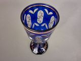a blue vase with a design on it sitting on a table