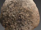 a close up of a stone object with a spiral design on it