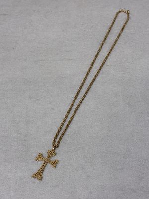 a gold necklace with a cross on it