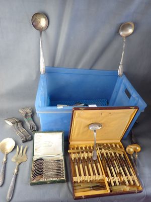 silverware and silverware in a blue box on a table