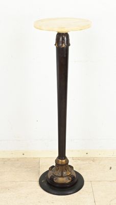 an image of a table with a marble top on a tile floor