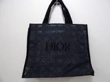 a black tote bag hanging from a hook on a wall