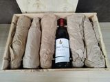 a wooden box with a bottle of wine and a bunch of rolls of paper