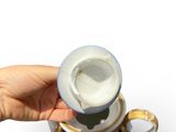 a hand that is holding a cup with a handle