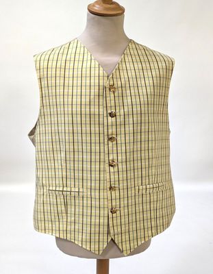 a close up of a mannequin wearing a yellow and black checkered vest