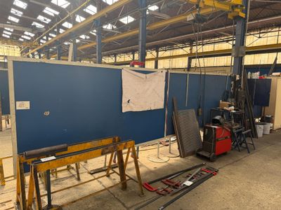 an image of a factory with a large blue screen