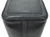 a close up of a black purse on a white surface