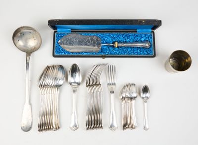 silverware and spoons laid out on a white surface