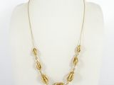 a gold necklace on a mannequin mannequin mannequin mannequin mannequin mannequin mannequin mannequin mannequin