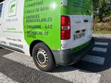 a green and white van parked on the side of the road