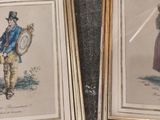 two framed pictures of a man and a woman holding a shield and a shield