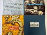trois livres posés sur une table, accompagnés d'une lettre manuscrite et de la photo d'un homme